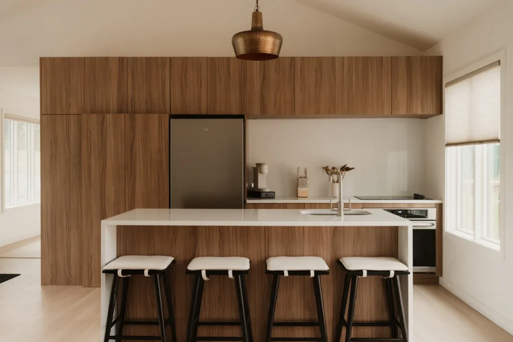 Sunlit modern kitchen with wood cabinetry and a kitchen island